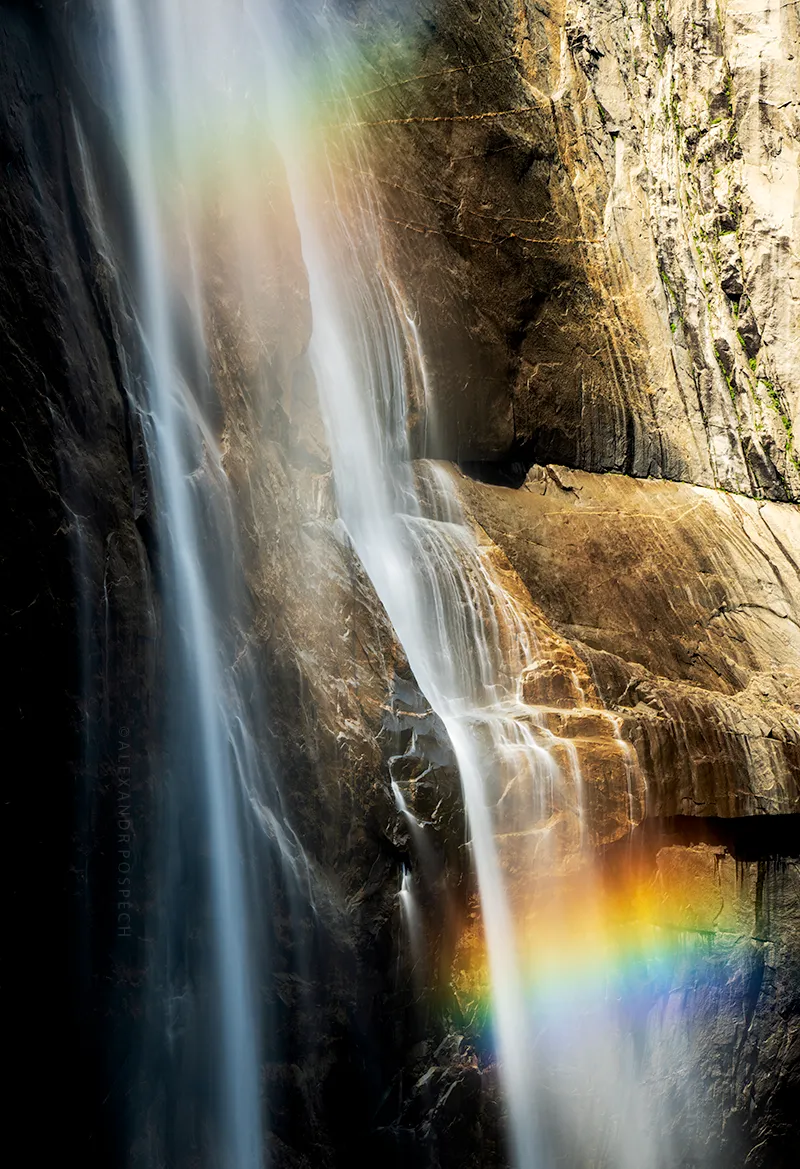 Long exposure photograph of Yosemite Waterfall captured with double rainbow around it