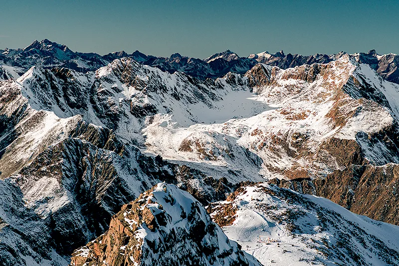 Peaks of Austrian Alps covered in snow during a sunny day