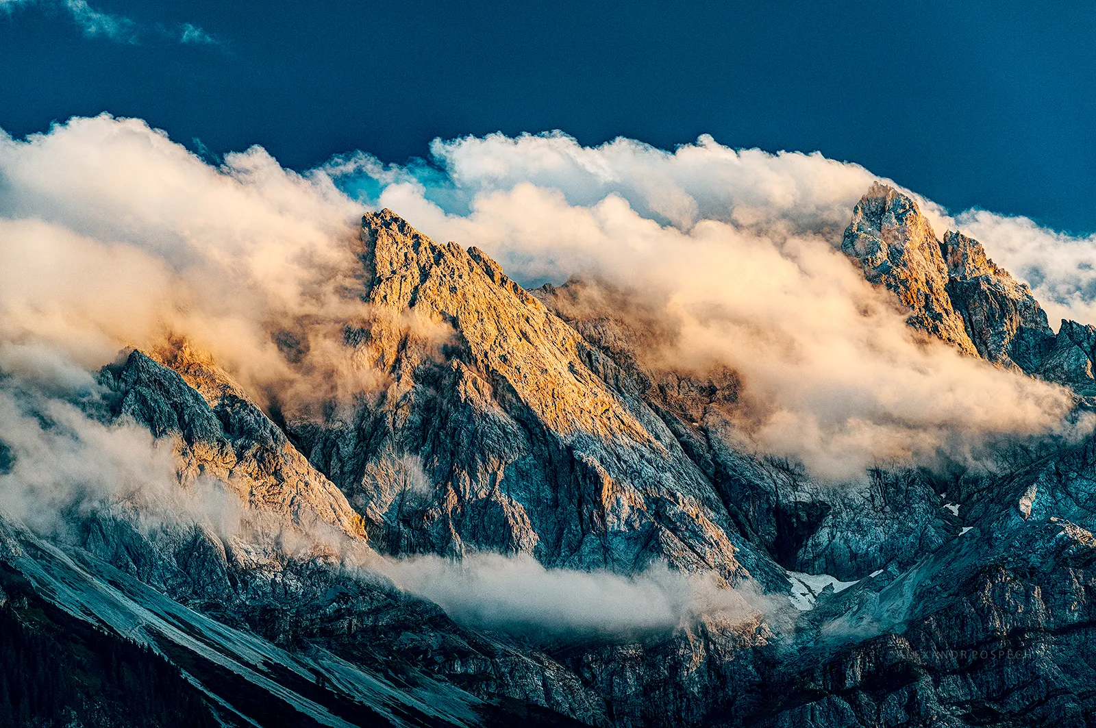 Cloud formation around the tallest peak of German Alps - Zugspitze during the sunset